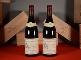 two bottles of wine sitting next to each other on a table