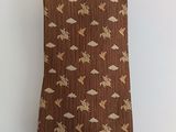 brown necktie with flying birds and clouds on a white background