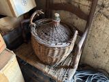 a wicker chair with a basket on top of it