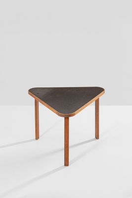 a close up of a table with a black top on a white surface