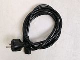 a black cord that is plugged into a white wall