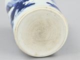 a blue and white vase sitting on top of a table