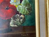 a picture of a painting of flowers in a gold frame