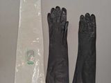 several pairs of gloves, gloves, gloves, and a bag on a table