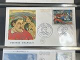 three stamps on a table with a picture of a man and a woman