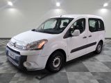 the small white van is parked on a checkered tile floor