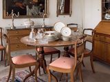 a dining room with a table, chairs, and a china cabinet