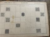 an old book with stamps on it sitting on a table