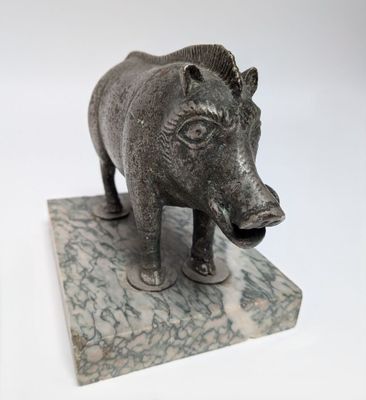 a statue of a boar on a marble base