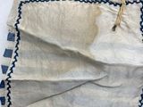 a close up of a piece of cloth on a white surface