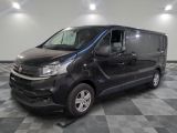 the black van is parked on a checkered tile floor