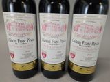 three bottles of wine sitting on top of a table next to each other
