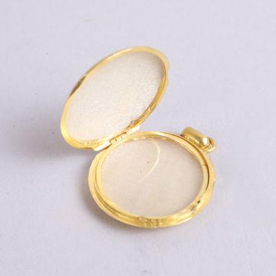 an image of a gold locke with a white stone inside