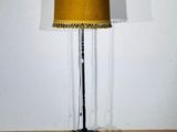 floor lamp in a room with a yellow shade on top of it
