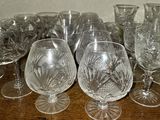 a lot of empty wine glasses on a wooden table