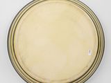 yellow and black plate sitting on a white surface with a white background