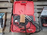 a red tool case with tools in it on a pallet