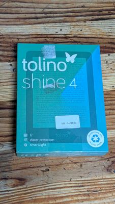 a close up of a box of toothpaste on a wooden table