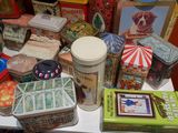 many different tins and tin cans on a table