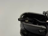 a black purse with a cell phone in it