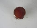 a small red object in the middle of a white surface