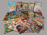 a lot of comic books that are on the table