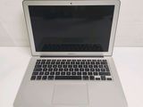 an open laptop computer sitting on top of a white table