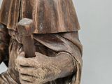 statue of a man holding a hammer in his right hand
