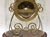 a glass dome with a clock inside of it