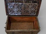 a small wooden chest with a decorative design on the inside