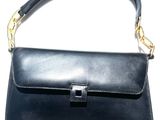 black leather handbag with gold hardware and chain strap