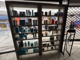 a display case with many bottles of hair products in it