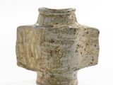 a vase that is sitting on a white surface