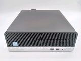 the hp desktop computer is sitting on a white surface with a blue sticker on it
