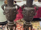 two vases sitting on top of a rug on the floor