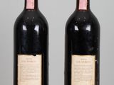 two bottles of wine that are sitting on a table