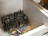 a lot of screws and nuts in a white box