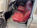a red seat in the back of a car with the door open