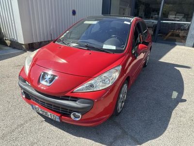 the small red car is parked in front of a building