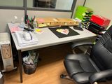 a desk with a chair and a computer on it