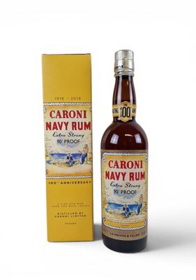 a bottle of caroni navy rum next to a box