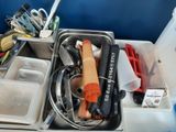 a sink filled with lots of assorted kitchen utensils