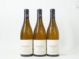 trois bouteilles de vin posées sur une table l'une à côté de l'autre