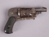 an old gun that is on display on a table