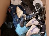 a cardboard box filled with clothes and a pair of shoes