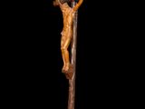 a statue of jesus on the cross on a black background