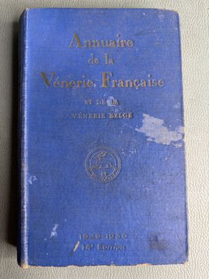 an antique blue book sitting on top of a white table