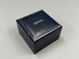 a close up of a black box with a gold logo on it