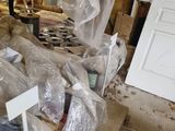 a pile of items in a room with a door in the background