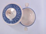 a blue and white bowl and a white bowl on a table